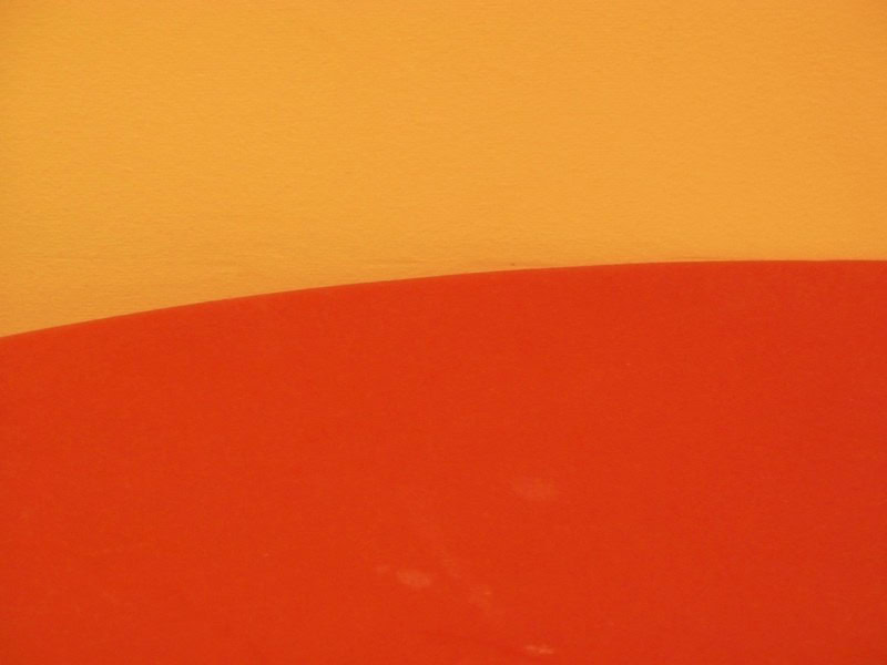 Close-up of a textured orange and yellow surface with a curved transition.